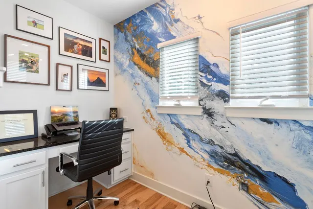 a dining room with furniture and a window