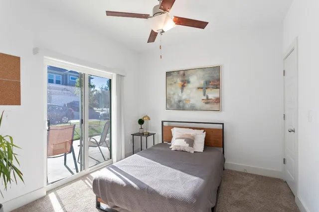 a bedroom with a large bed and a chandelier