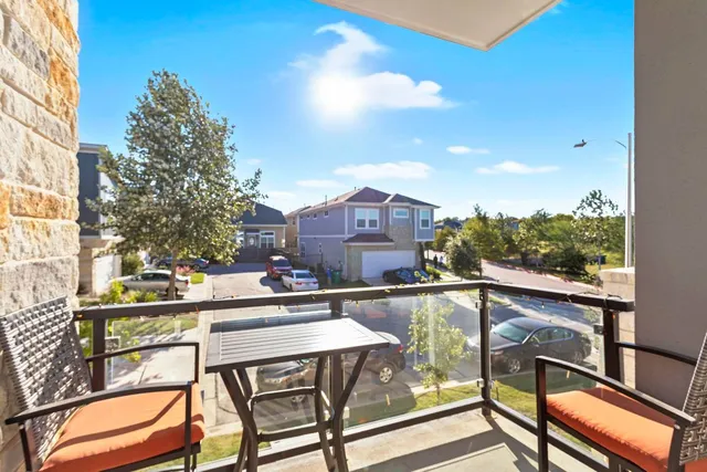 a view of a chairs and table in a balcony