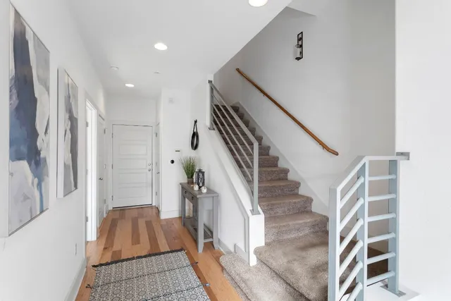 a view of entryway with furniture and wooden floor