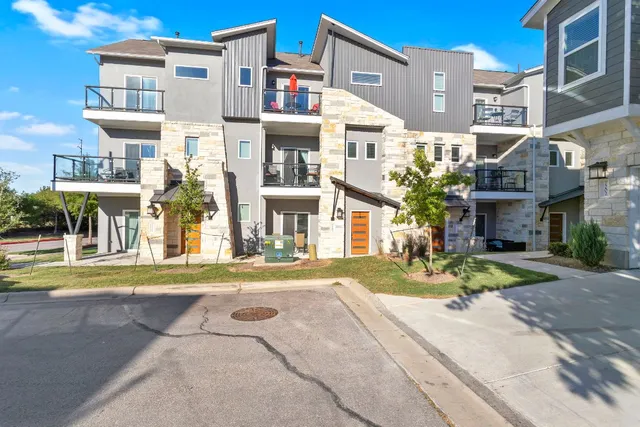 a view of a white building among the street and a building