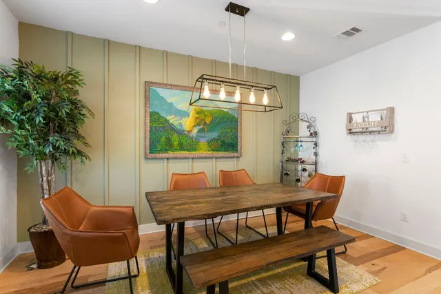 a view of a dining room with furniture and a potted plant