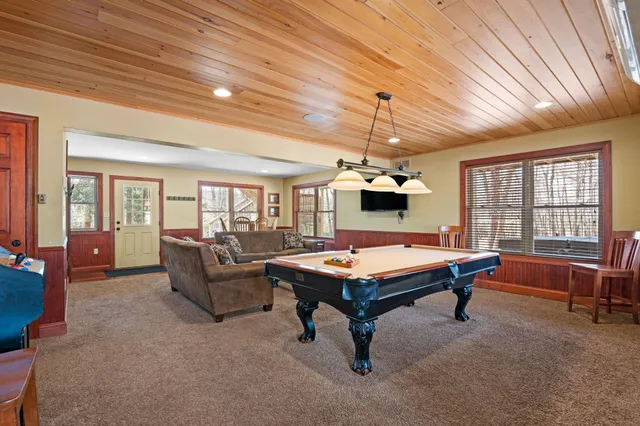 a room with furniture pool table and flat screen tv