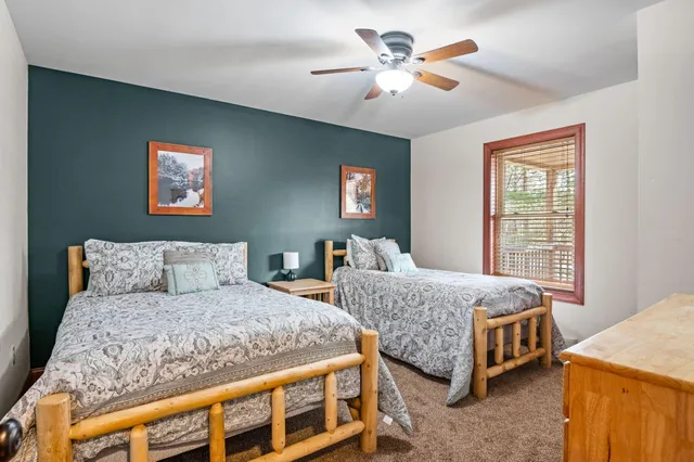 a bed sitting in a bedroom next to a window