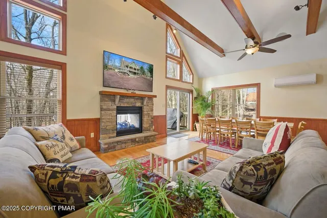 a living room with furniture stairs and a rug