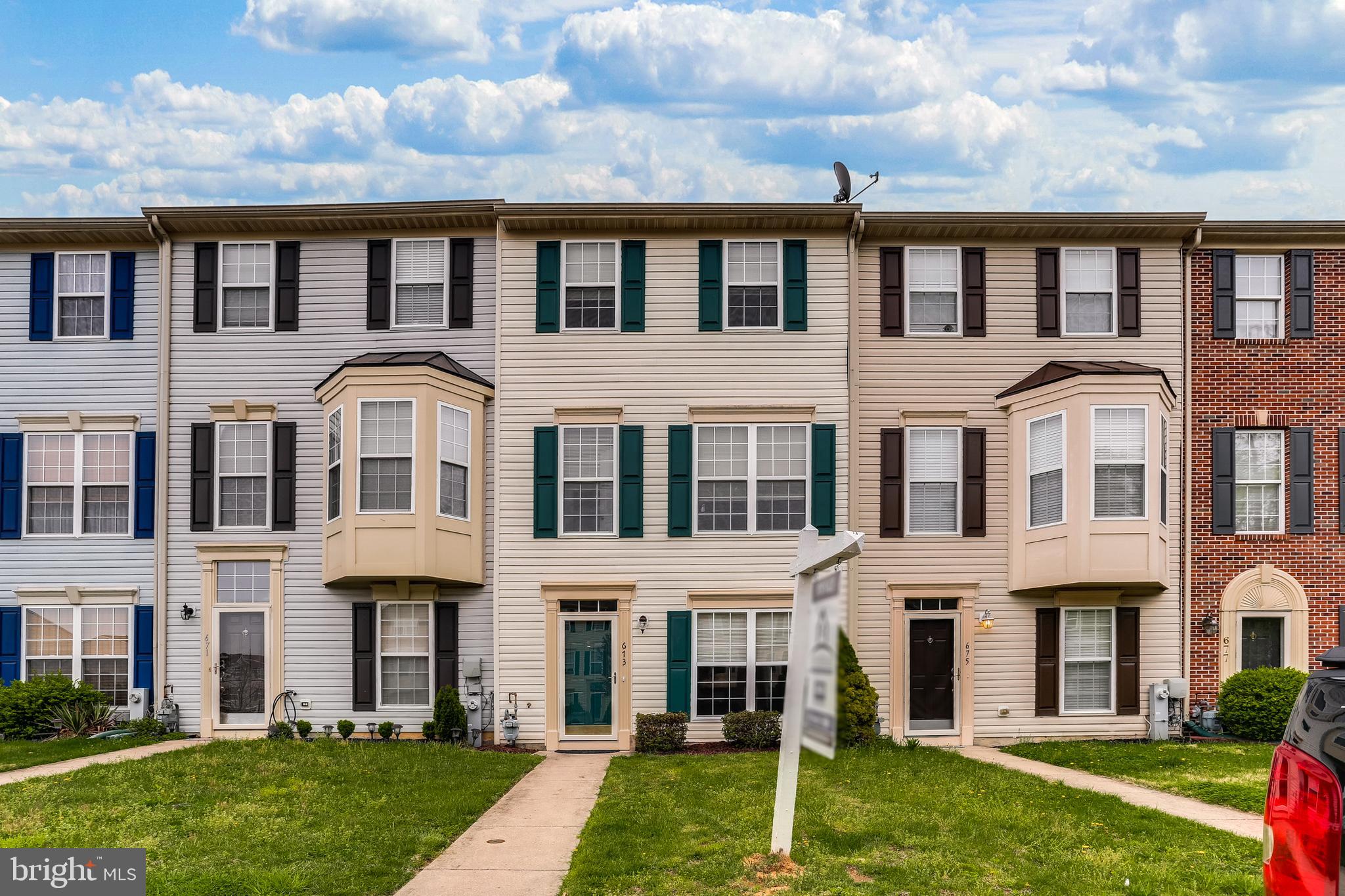 673 Hunting Fields Road Baltimore, MD 21220 - Photo 1 of 31 a front view of a residential apartment building with a yard