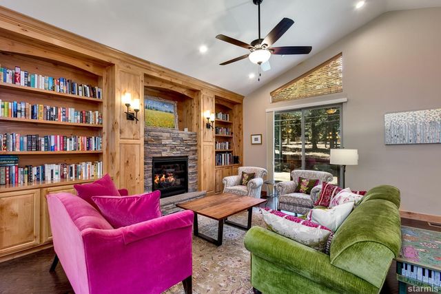 a living room with furniture fireplace and a large window