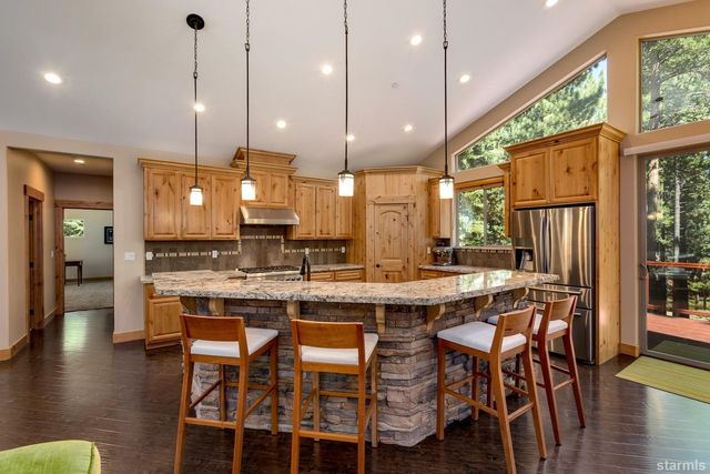 a dining table with chairs and wooden floor