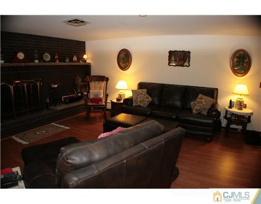 337 East Greystone Road Old Bridge, NJ 08857 - Photo 3 of 22 a living room with furniture and a fireplace