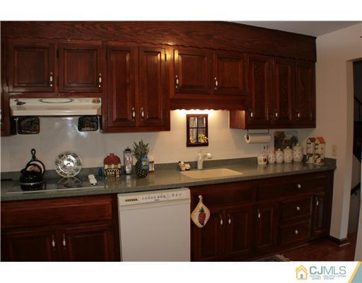 337 East Greystone Road Old Bridge, NJ 08857 - Photo 4 of 22 a kitchen with a sink and cabinets