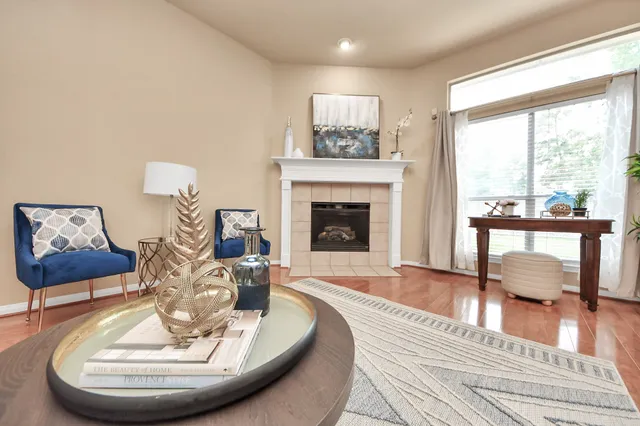 a living room with furniture and a fireplace