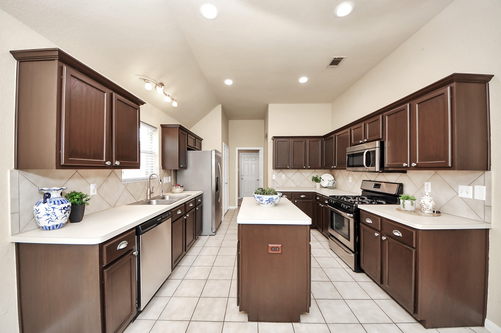 19123 Center Park Drive Spring, TX 77373 - Photo 35 of 42 a kitchen with stainless steel appliances granite countertop a sink stove refrigerator and cabinets
