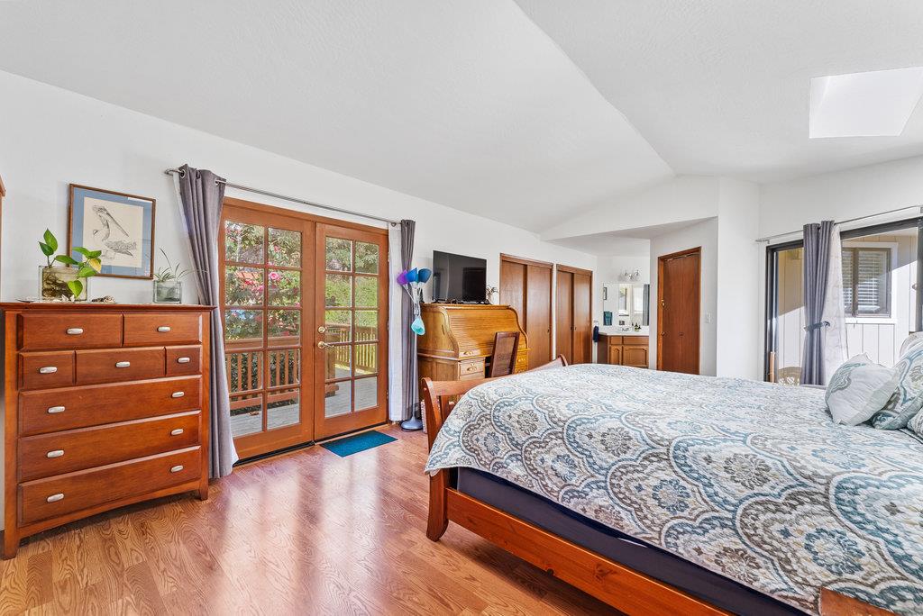 60 Robak Drive La Selva Beach, CA 95076 - Photo 17 of 44 a bedroom with a bed and wooden floor
