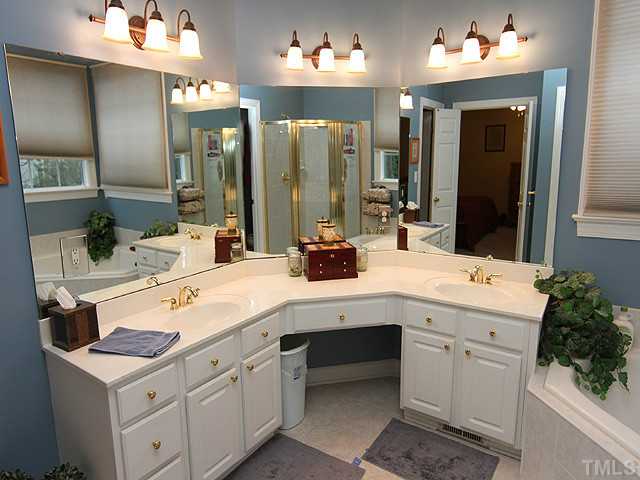 3805 Evander Way Raleigh, NC 27613 - Photo 13 of 23 A dual vanity is separated with a makeup/dressing corner.