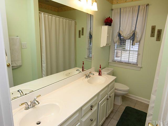 3805 Evander Way Raleigh, NC 27613 - Photo 19 of 23 The hall bath has dual vanities...immaculate!