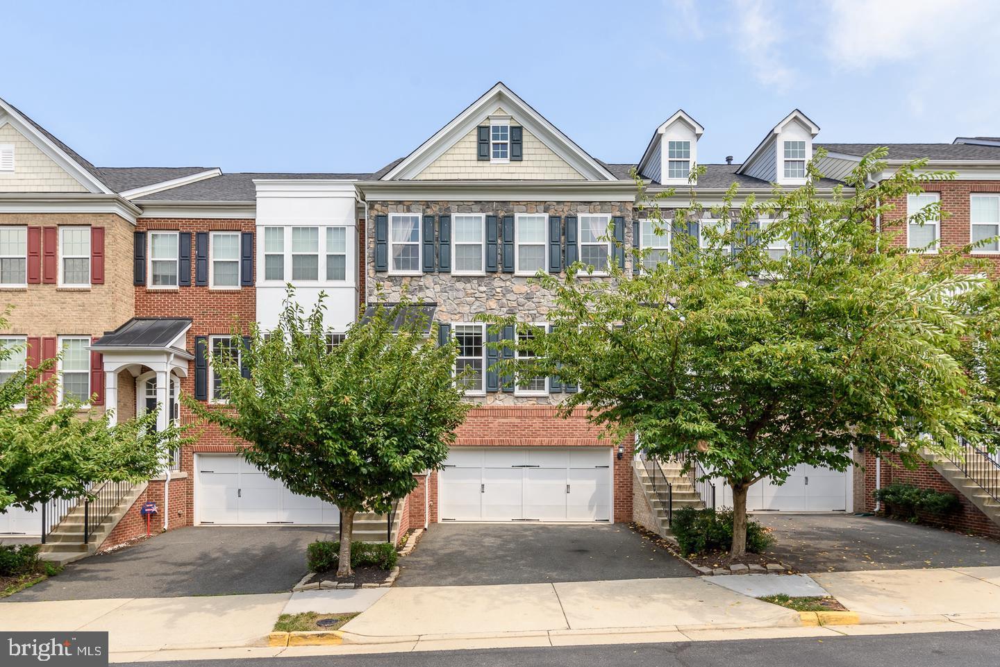 42740 Keiller Terrace Ashburn, VA 20147 - Photo 1 of 54 a front view of a house with garden