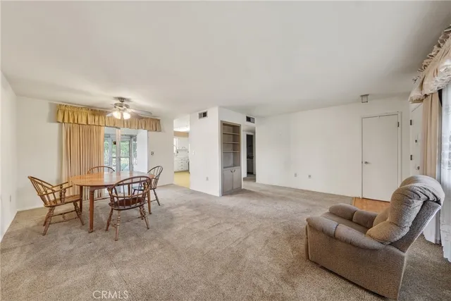 a living room with furniture and a dining table