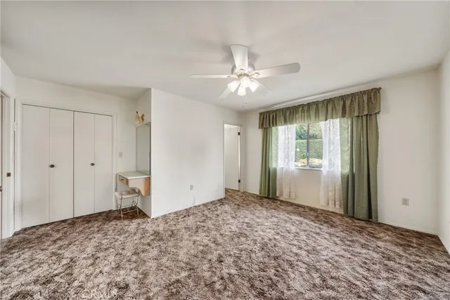 a view of a bedroom with closet and window