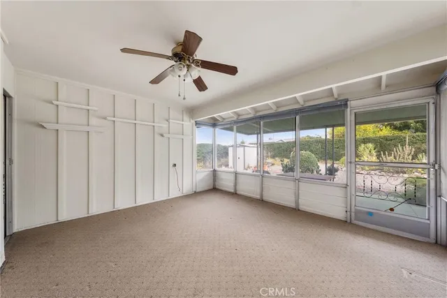 a view of room with window and a ceiling fan