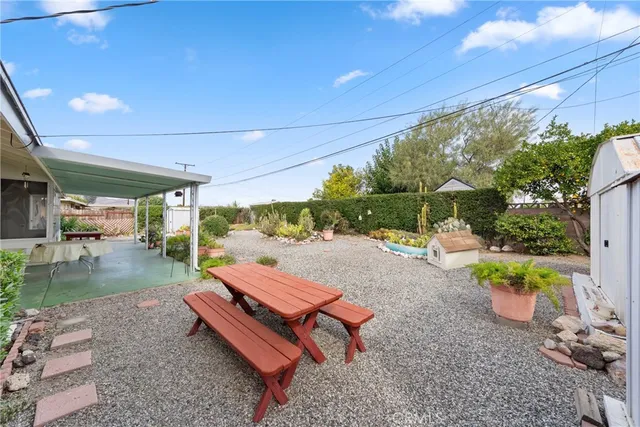 a backyard of a house with table and chairs