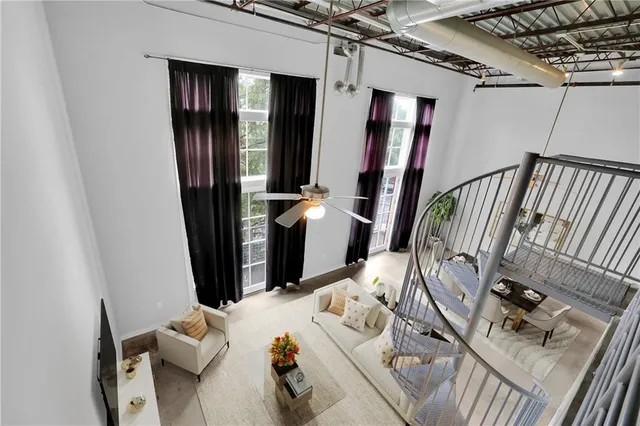 a bed sitting in a bedroom next to a chandelier