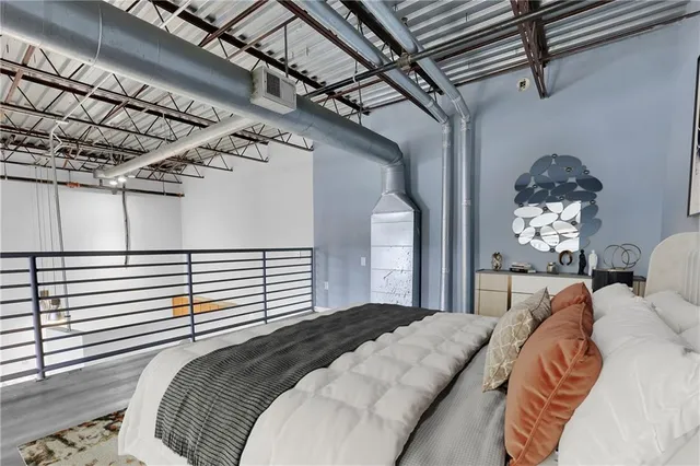 a bed sitting in a bedroom next to a balcony