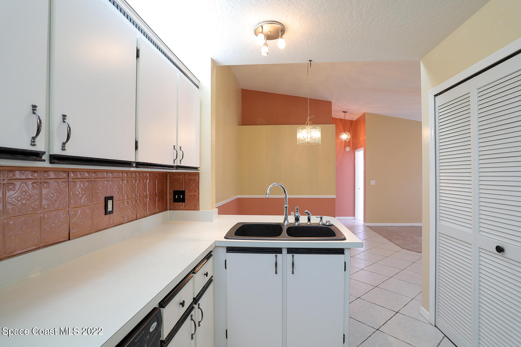 1943 Quail Ridge Court, Unit 604 Cocoa, FL 32926 - Photo 13 of 38 a kitchen with a sink and cabinets