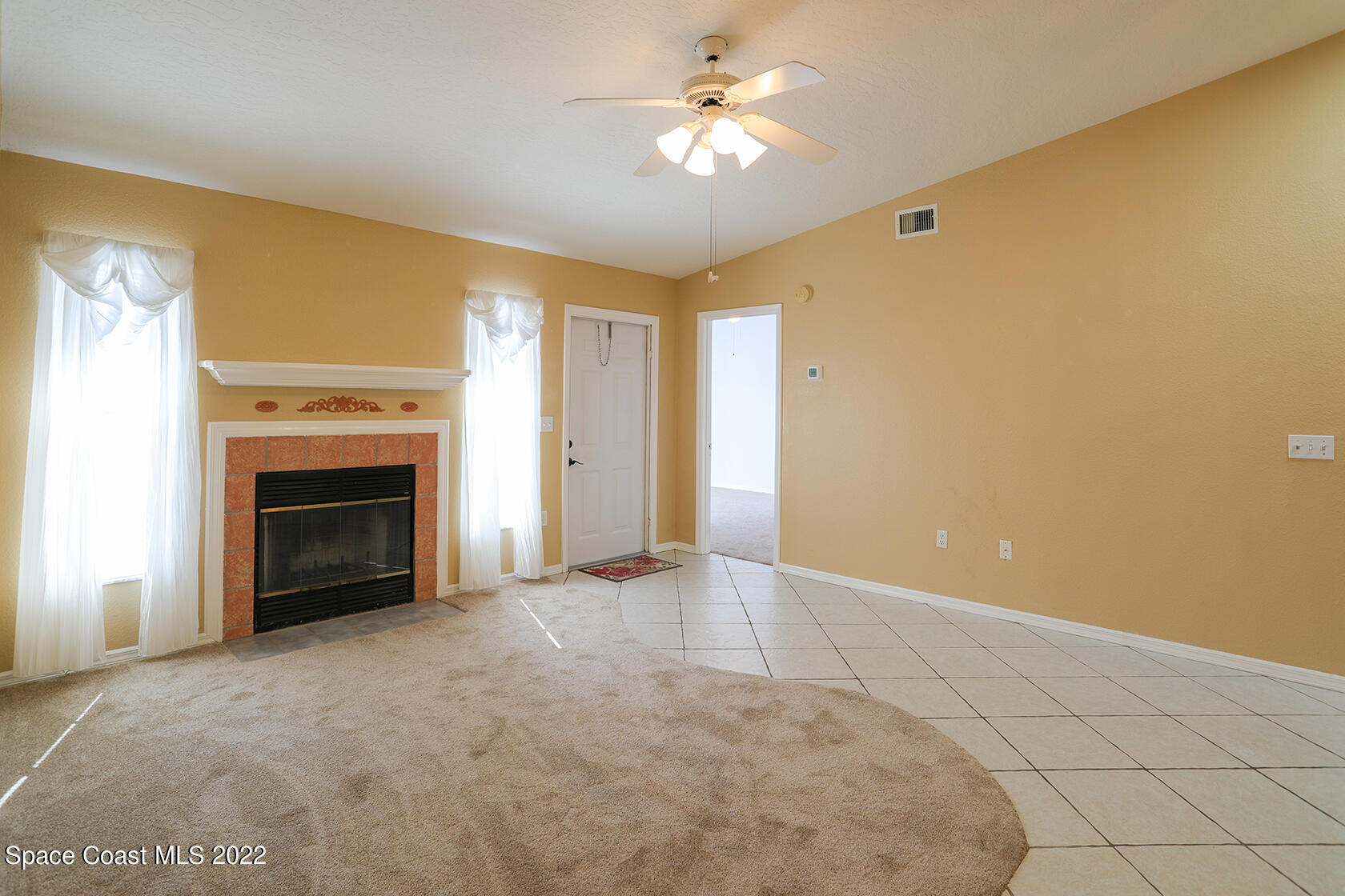1943 Quail Ridge Court, Unit 604 Cocoa, FL 32926 - Photo 18 of 38 a view of a livingroom with a fireplace and a ceiling fan