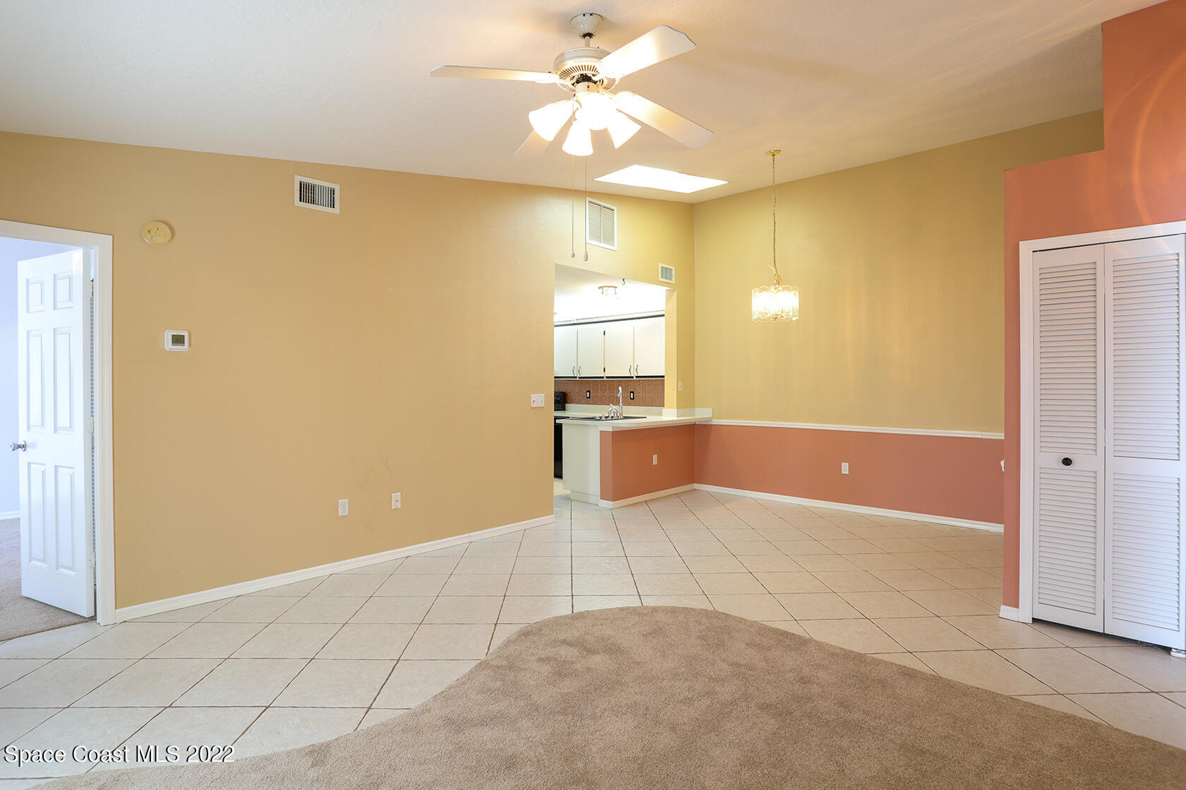 1943 Quail Ridge Court, Unit 604 Cocoa, FL 32926 - Photo 19 of 38 a view of a kitchen with a cabinet and a chandelier fan
