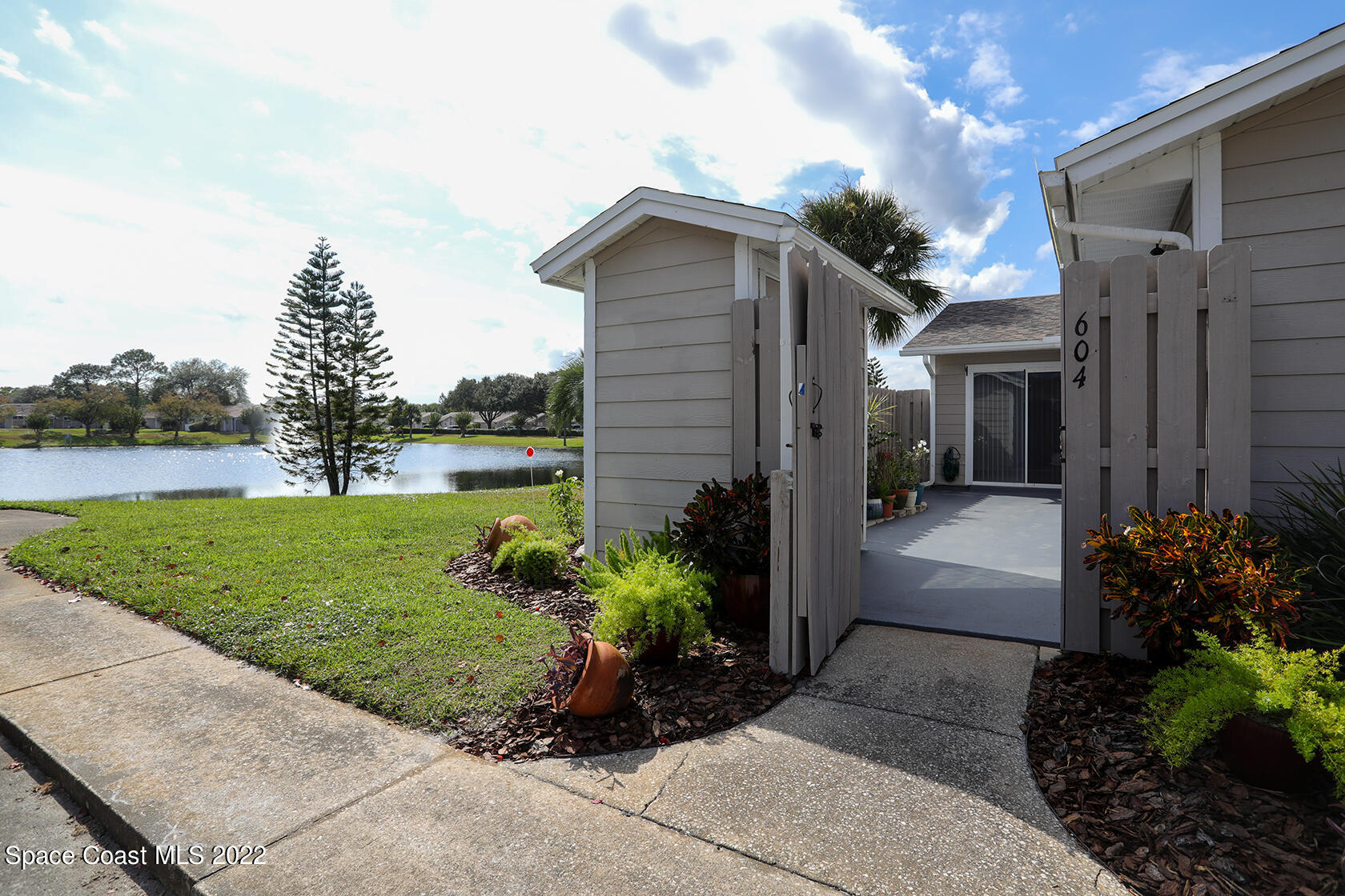 1943 Quail Ridge Court, Unit 604 Cocoa, FL 32926 - Photo 2 of 38 a front view of a house with garden
