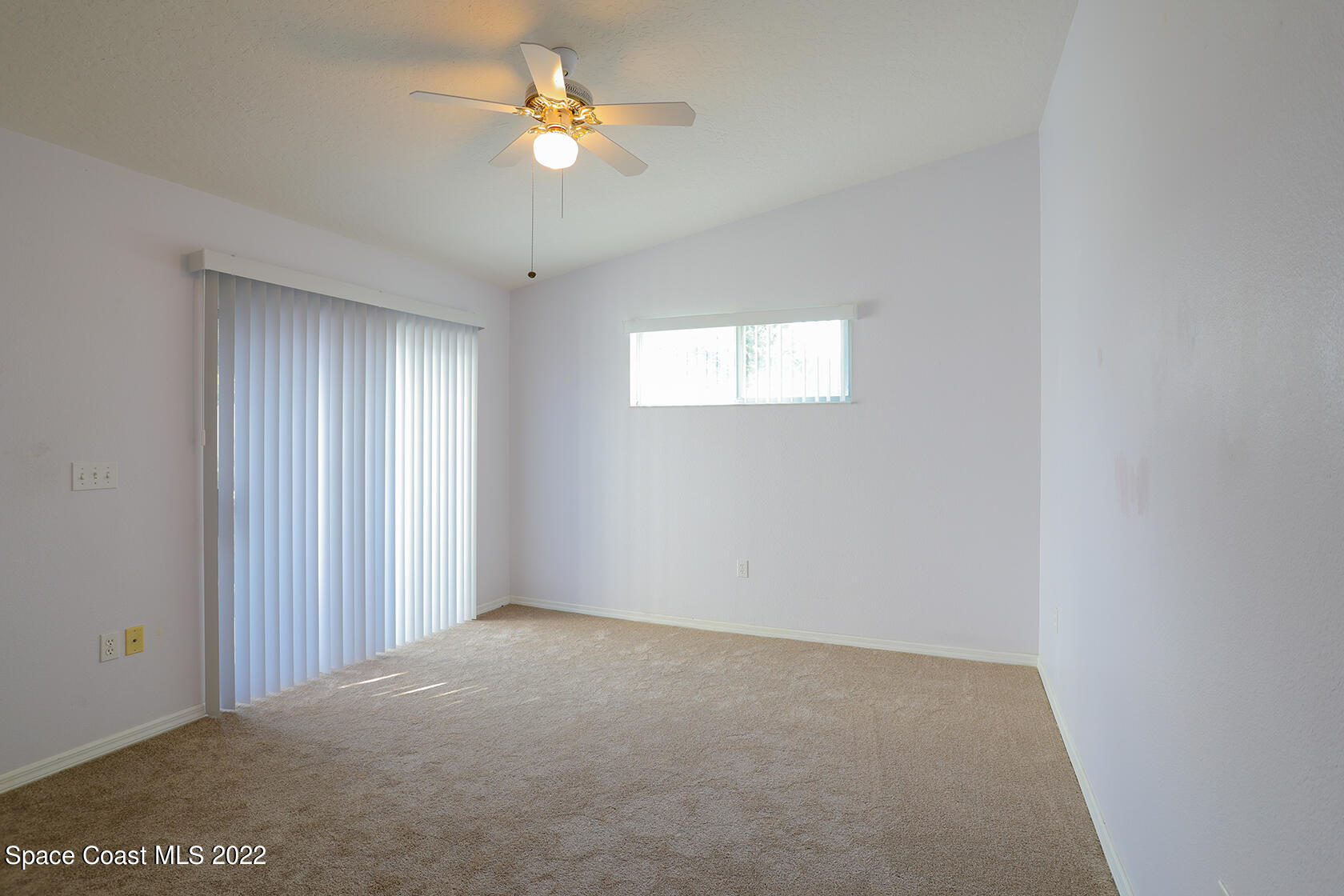 1943 Quail Ridge Court, Unit 604 Cocoa, FL 32926 - Photo 22 of 38 an empty room with a window and a ceiling fan