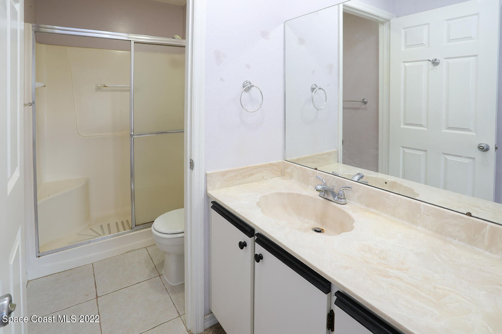 1943 Quail Ridge Court, Unit 604 Cocoa, FL 32926 - Photo 24 of 38 a bathroom with a sink a toilet and shower