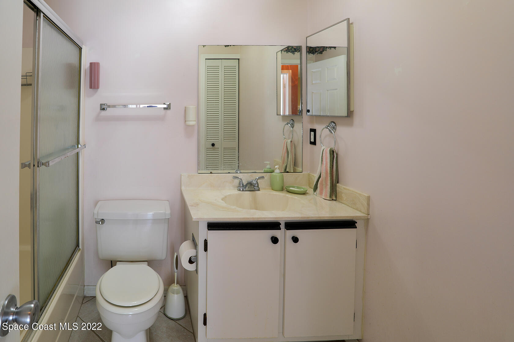 1943 Quail Ridge Court, Unit 604 Cocoa, FL 32926 - Photo 31 of 38 a bathroom with a sink toilet and a mirror