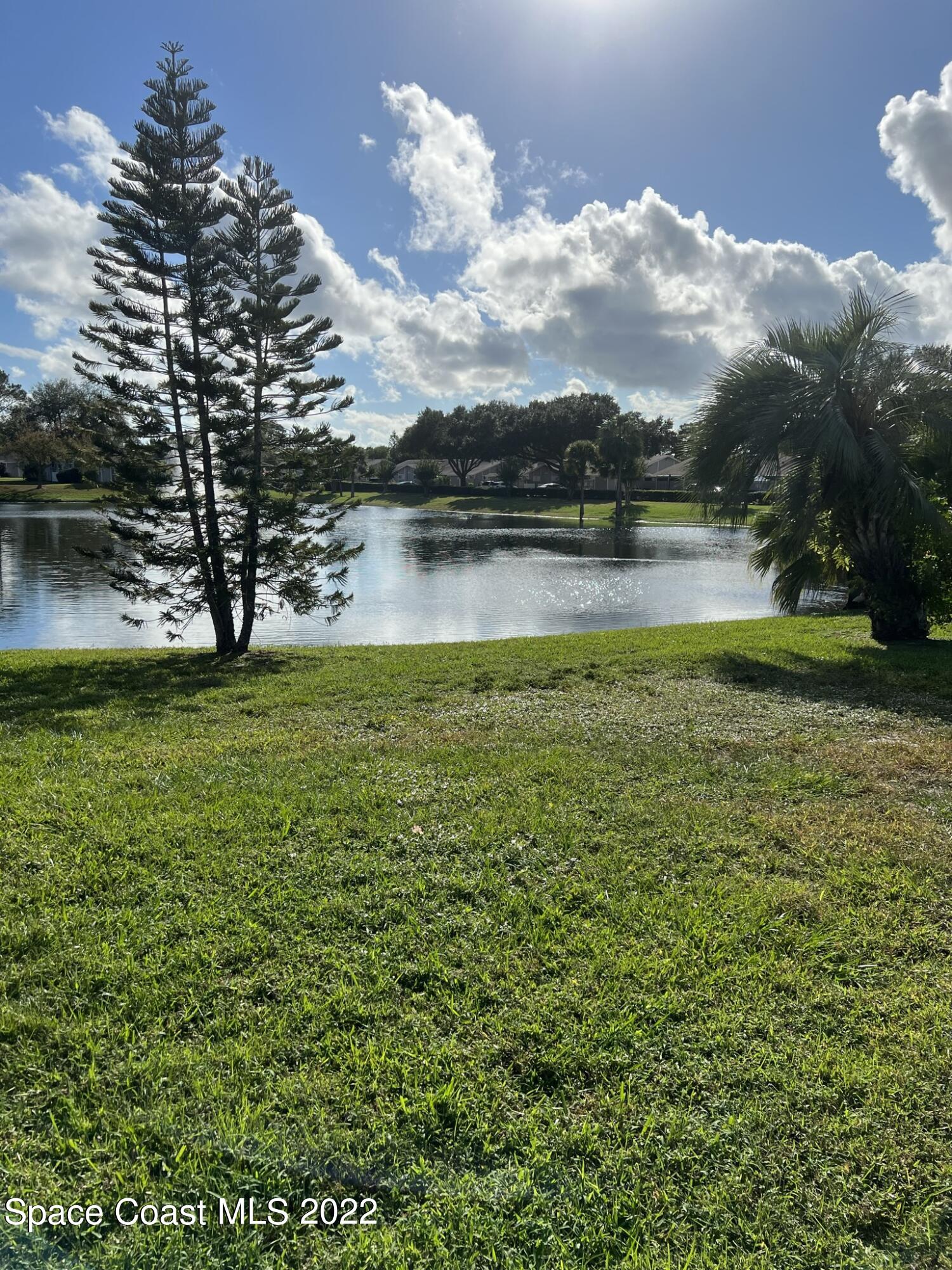 1943 Quail Ridge Court, Unit 604 Cocoa, FL 32926 - Photo 32 of 38 a view of a lake with houses in the back