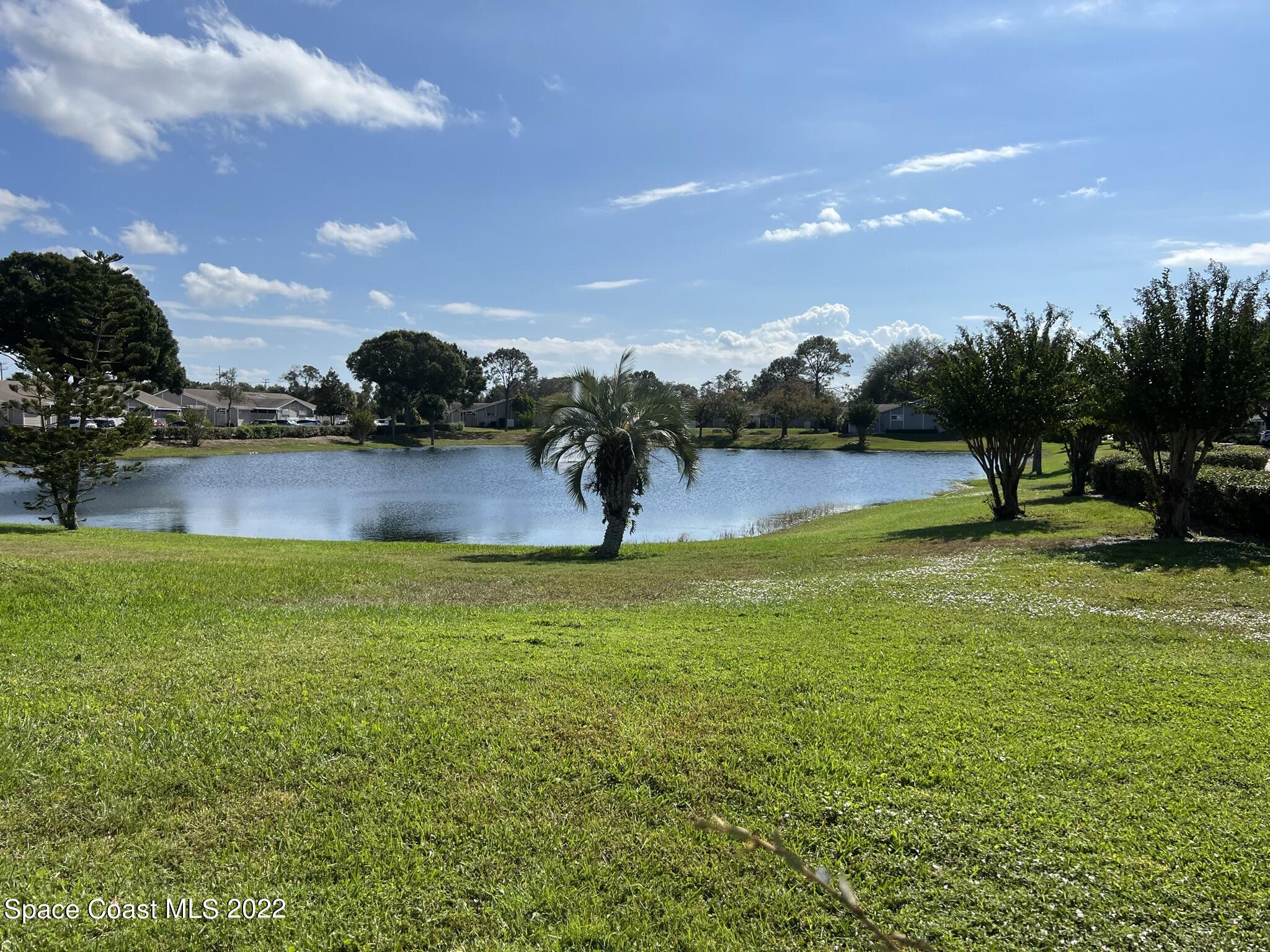 1943 Quail Ridge Court, Unit 604 Cocoa, FL 32926 - Photo 33 of 38 a view of a lake with houses in the back
