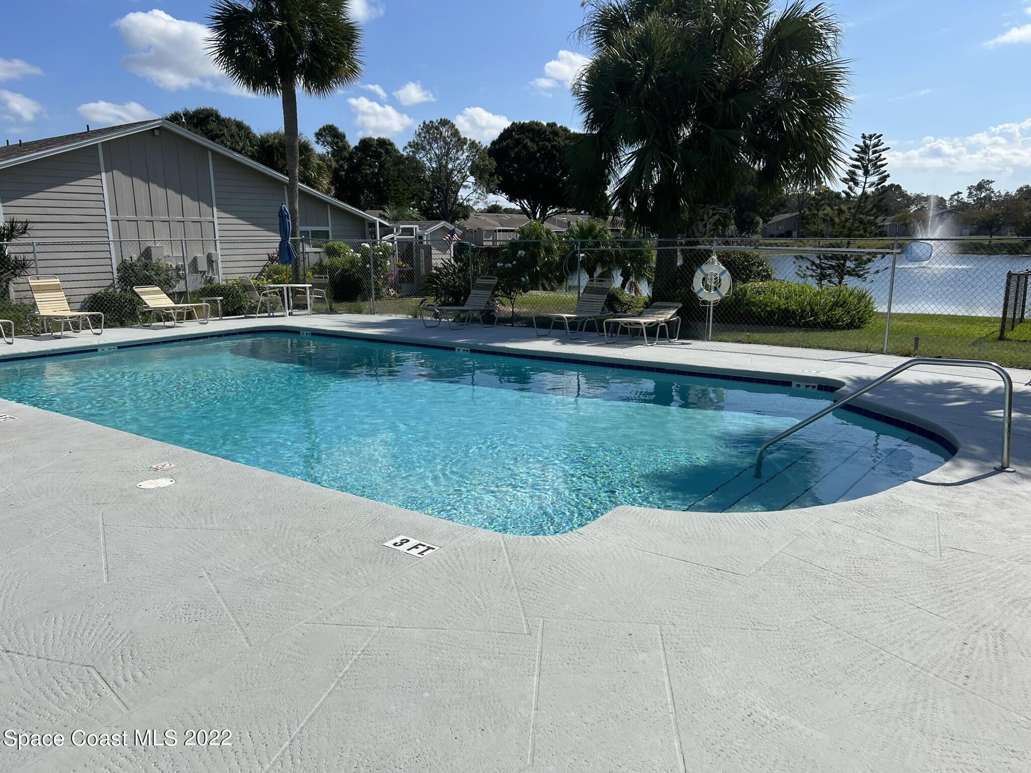 1943 Quail Ridge Court, Unit 604 Cocoa, FL 32926 - Photo 34 of 38 a view of a swimming pool with a patio