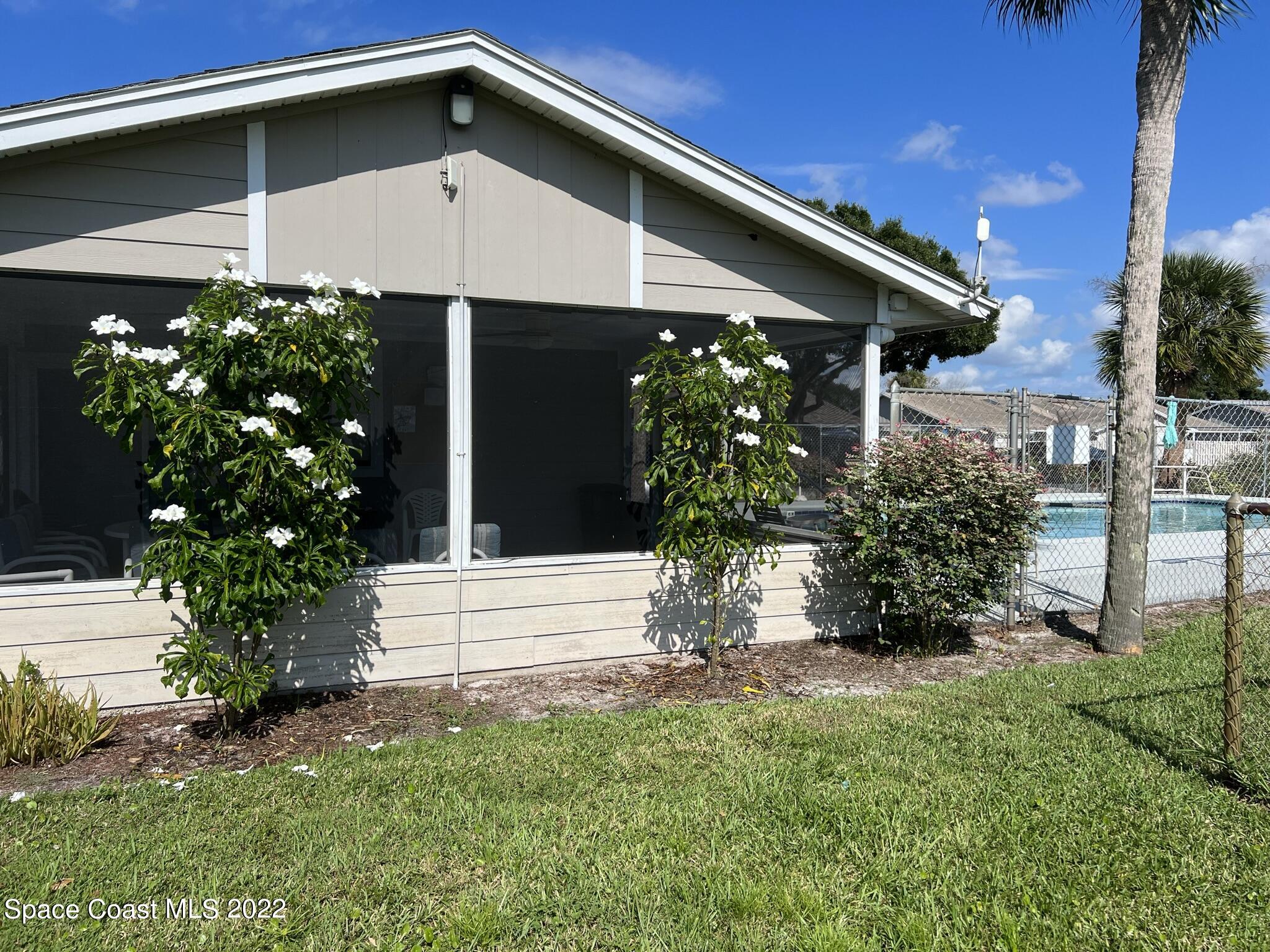 1943 Quail Ridge Court, Unit 604 Cocoa, FL 32926 - Photo 35 of 38 a front view of a house with a yard