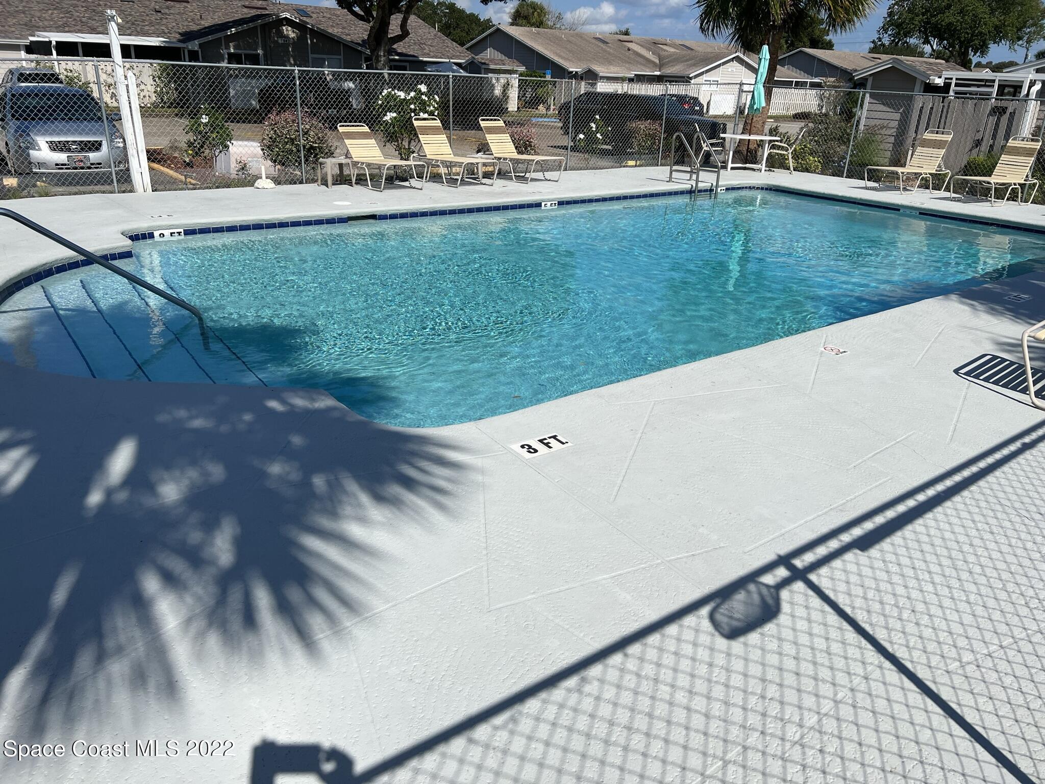 1943 Quail Ridge Court, Unit 604 Cocoa, FL 32926 - Photo 36 of 38 a view of a swimming pool with a yard