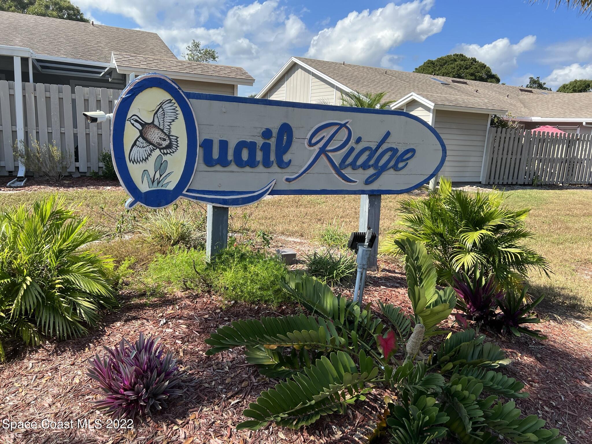 1943 Quail Ridge Court, Unit 604 Cocoa, FL 32926 - Photo 38 of 38 a view of sign board with buildings in background