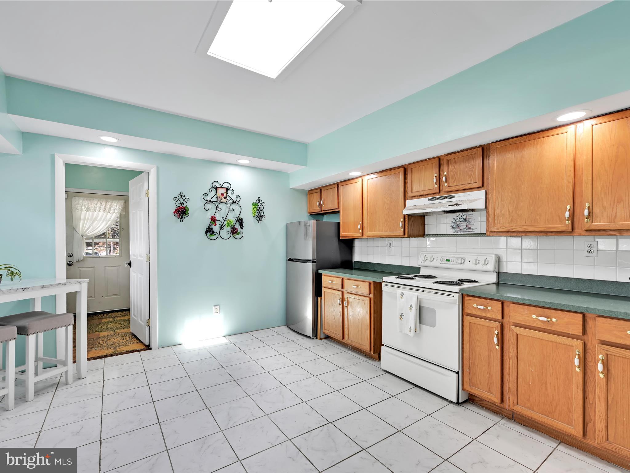125 West Washington Street Shenandoah, PA 17976 - Photo 14 of 29 a large kitchen with stainless steel appliances granite countertop a refrigerator and sink