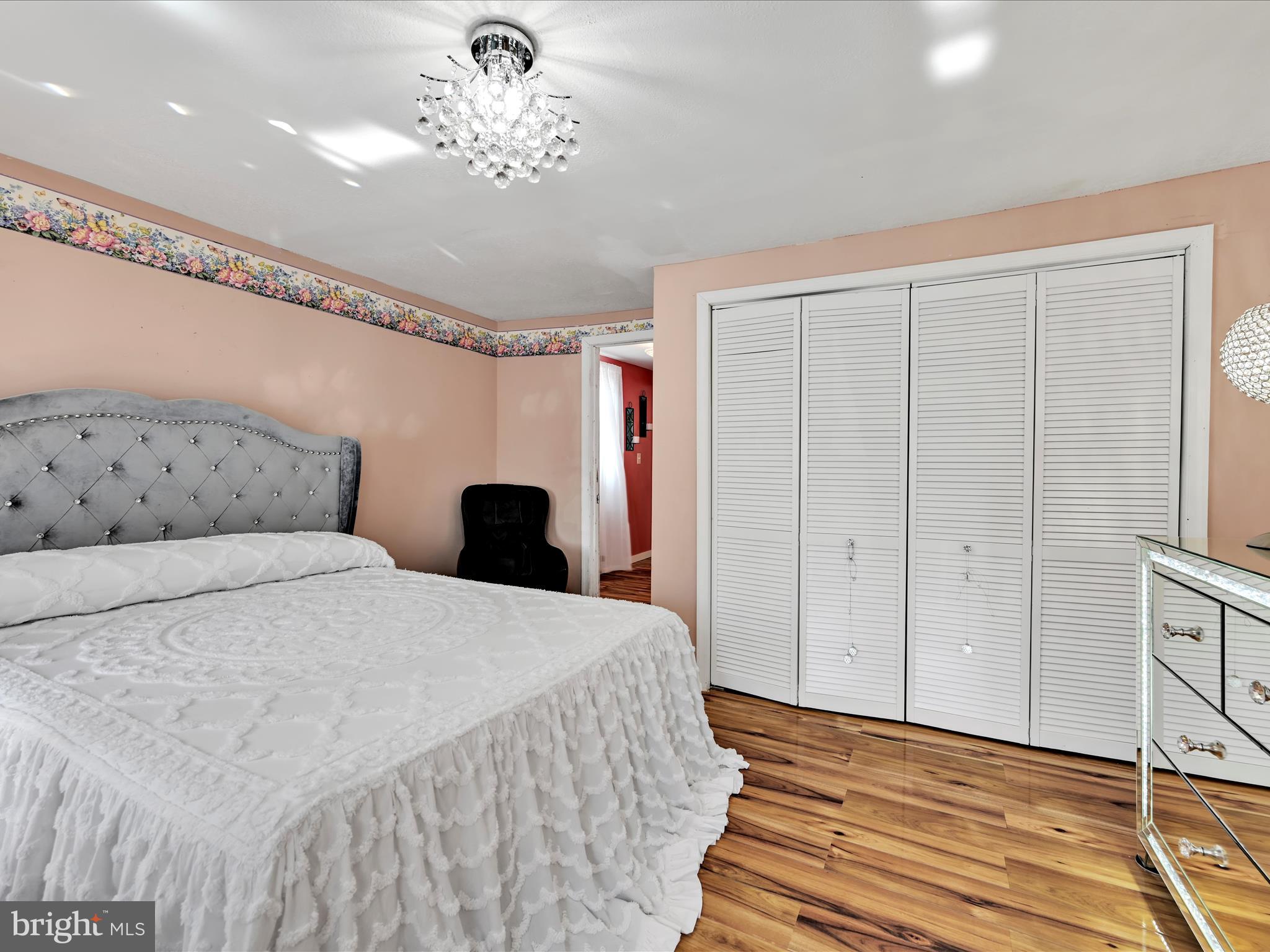 125 West Washington Street Shenandoah, PA 17976 - Photo 21 of 29 a bedroom with a bed and a chandelier