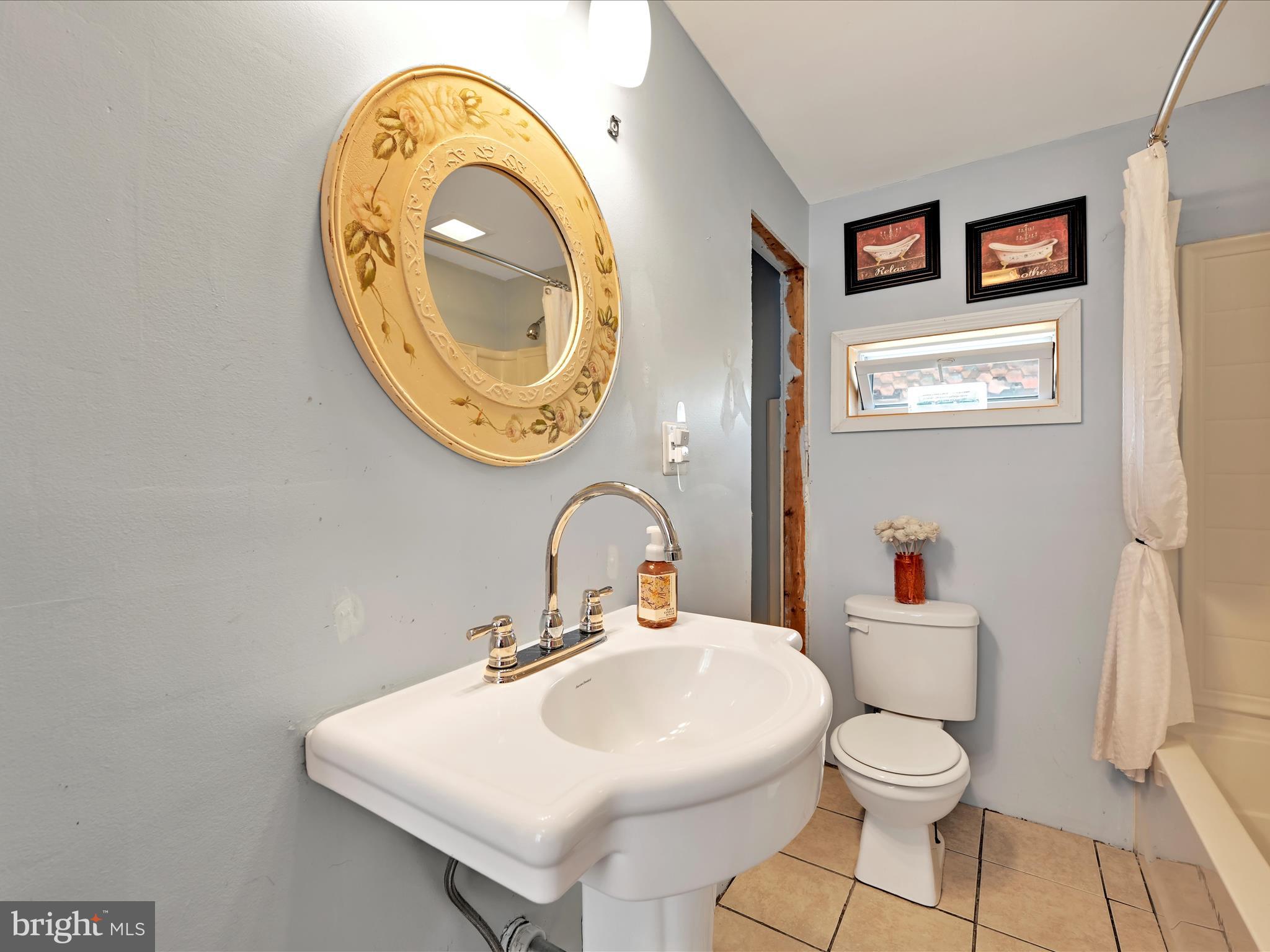 125 West Washington Street Shenandoah, PA 17976 - Photo 23 of 29 a bathroom with a toilet a sink and a mirror