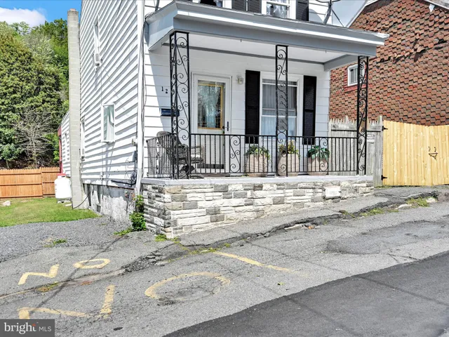 a living room with furniture flat screen tv and window