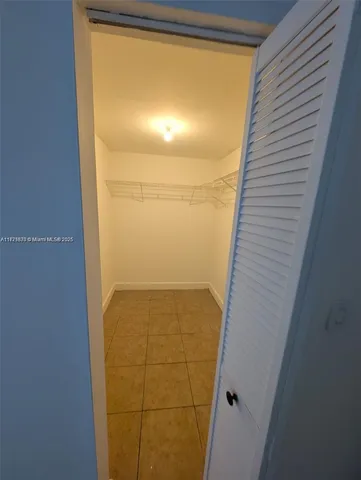 a view of an empty room and a window