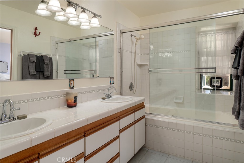 978 Balboa Street Morro Bay, CA 93442 - Photo 11 of 34 a bathroom with a granite countertop sink mirror and shower