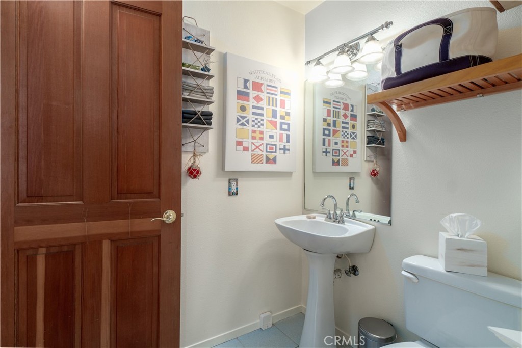 978 Balboa Street Morro Bay, CA 93442 - Photo 19 of 34 a bathroom with a sink a mirror and a toilet