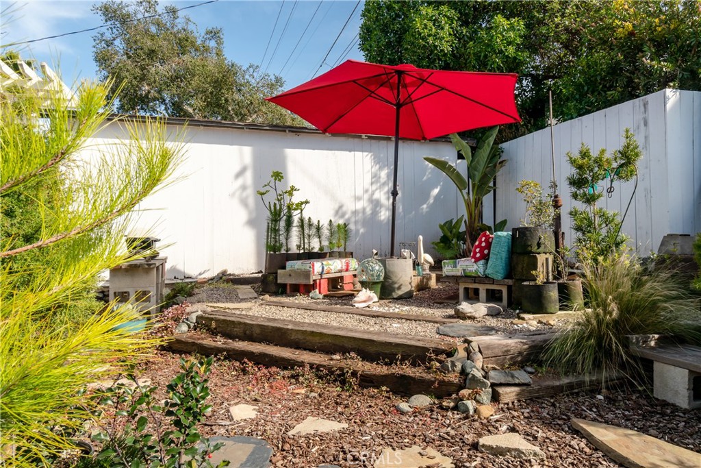 978 Balboa Street Morro Bay, CA 93442 - Photo 22 of 34 a table and chairs under an umbrella