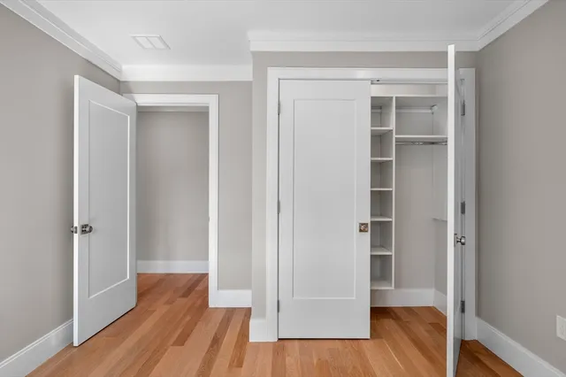 a view of empty room with wooden floor