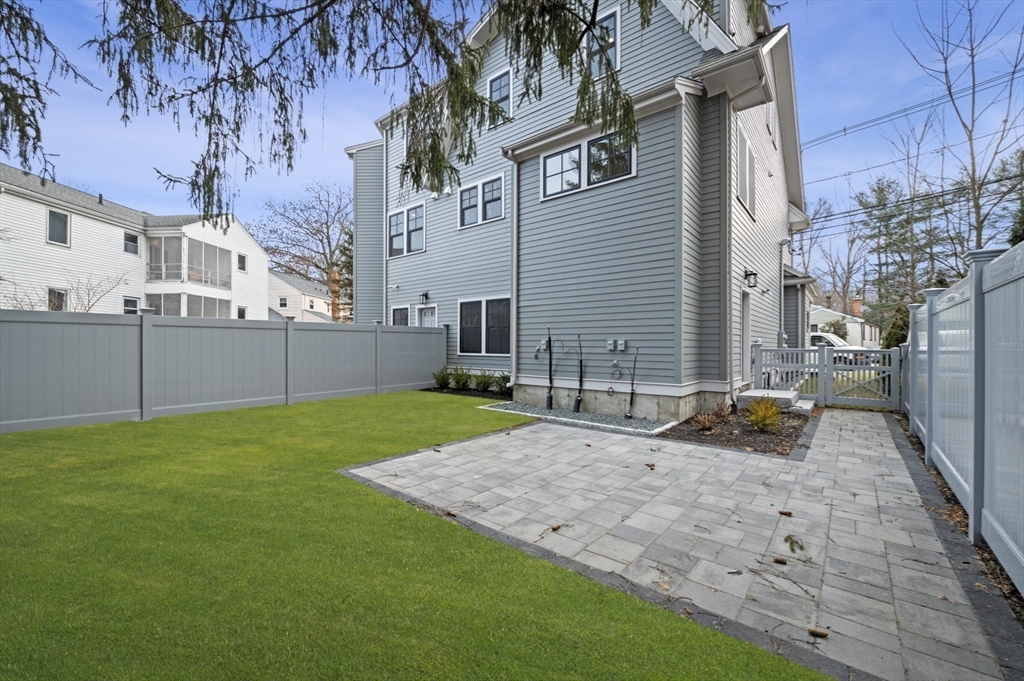799 Heath Street, Unit 2 Brookline, MA 02467 - Photo 21 of 21 a backyard of a house with lots of green space