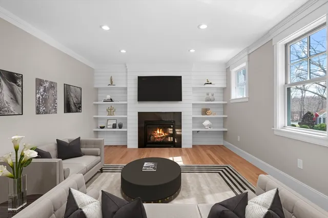 a living room with furniture a flat screen tv and a fireplace